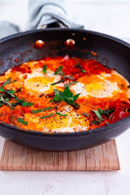 Shakshuka Poached Eggs In A Spicy Tomato Sauce Served With Warm Bread That S Shakshuka A Vegetarian Shakshuka Recipes Shakshuka Tasty Vegetarian Recipes