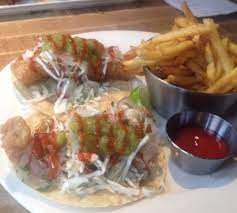 Assemble the tacos by adding the fish, cheese, chili garlic sauce, cabbage, pico de gallo, and green sauces. Fish Tacos Picture Of Earls Vancouver Island Tripadvisor