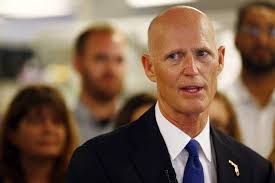 Gov. Rick Scott with 'some hesitation' signs online voter registration law