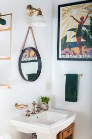 Vintage Brass Faucet On A White Sink In A Room With White Walls Decorated With A Framed Poster A Ro Bathroom Wall Decor Modern Bathroom Decor Boho Bathroom