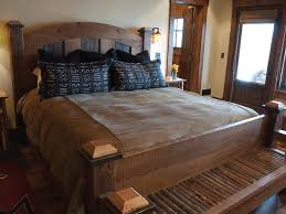 For a bench that's just right, the length should stretch across most of your bed, leaving a few inches of space on either side. Rustic Guest Room With Wooden King Size Bed Hgtv