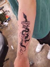 Snake Wrapped Around A Hand Holding A Rose By Caro Lacid At No Regrets In London Uk Cool Forearm Tattoos Hand Holding Tattoo Wrap Around Tattoo