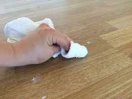 To avoid leaving streaks, rub in the direction of the wood grain. How To Get Paint Off Of Laminate Or Vinyl Floors Painted Vinyl Floors Laminate Flooring Vinyl Laminate Flooring