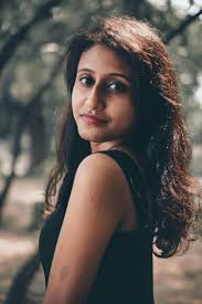 A woman with long hair standing in a forest photo