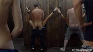 Crowd of men and a whole bunch of glory holes and glory tables in one room