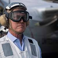 Capt. David Snowden, executive officer of the Nimitz-class aircraft carrier  USS Harry S. Truman (CVN 75), delivers remarks at a safety stand down in  the hangar bay aboard the aircraft carrier USS
