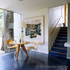 In The Dining Area A Print By Candida Hofer Hangs On A Wall Next To A Jean Prouve Table And Eames Dining Chairs David Eames Dining Chair Interior Eames Dining