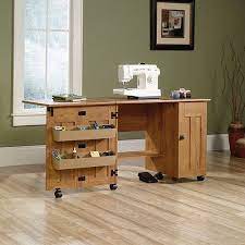 The sauder sewing and craft table, multiple finishes features two adjustable shelves and two storage bins that provide plenty of room for your equipment and accessories. Sauder Sewing And Craft Table Amber Pine Finish Walmart Com In 2021 Craft Tables With Storage Sewing Rooms Sewing Craft Table
