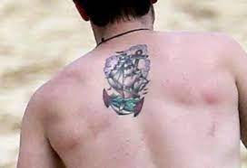 Which star has birds flying around her arm? Josh Hutcherson Photo Josh S Upper Back Tattoo Josh Hutcherson Josh Hutcherson Tattoo Back Tattoo