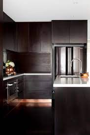 Sebring design build for more modern kitchen designs, choosing two contrasting tones can create a striking color scheme.this kitchen features bright white cabinets with a dramatic charcoal grey stacked stone backsplash. Modern Espresso Kitchen Cabinets Design Ideas