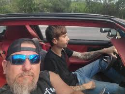 Picking up his brothers at the bus stop! First car ride since coming home!