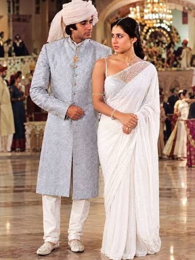 The image appears to show actors Amitabh Bachchan and Smita Patil in a  still from the classic Hindi film Namak Halaal (1982) [1.4], likely during  the popular song sequence "Pag Ghunghroo Baandh". Amit