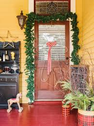The bright red and green colors of this decor look striking against a stark white background. 20 Easy Front Door Christmas Decorating Ideas Hgtv