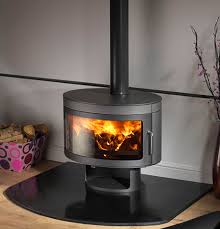 A new generation of wood stoves offers fuel efficiency, high combustion temperatures, and lower above: Hase Delhi Cylindrical Rotating Wood Burning Stove