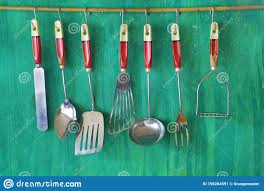 vintage kitchen utensils on green