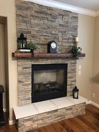 Stacked stone fireplaces are undeniably gorgeous but the natural stone, and the labor to install it, can be expensive. Manteau De Foyer Fait De Pierres Naturelles Home Fireplace Fireplace Design Stone Fireplace Designs