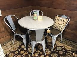 Bring your breakfast nook into the 21st century with this streamlined dining table. Novogratz Leo Farmhouse Round Dining Table With Sleek Slanted Metal Legs And Gia Metal Dining Chairs Set Of 4 Antique Vintage Brown Wooden Seat With Back Silver Base Piq