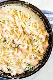 Pan seared garlic shrimp, broccoli and pasta tossed in creamy lightened up garlic alfredo sauce that contains no cream! Shrimp Fettuccine Alfredo Recipe Lemon Blossoms