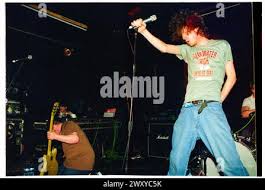 HUNDRED REASONS, EMO CONCERT, 2001: Colin Doran of the Emo rock band  Hundred Reaons jumps out into the crowd playing at Clwb Ifor Bach Welsh  Club in Wales, UK 14 May 2001.