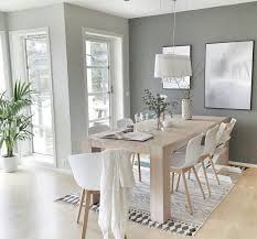 Dining Room With Light Gray Walls Light Wood Table And Floors White Chairs And Decor And Lots Of Natural Light Modern Dining Room House Interior Home Decor