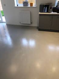 Oak veneer kitchen with hide n slide doors with leather handles and polished concrete floor and worktop. Kitchen Polished Concrete Flooring Polished Concrete Specialists