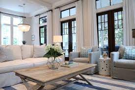 Curtains and walls are also white, while patterns accent the floor rug, throw pillows and the ceiling. Interior Design Ideas Coastal Style Living Room Apartment Living Room Home Living Room