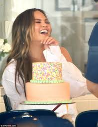 The couple, who will soon be celebrating the impressive cake appears to be largely naked, standing four tiers tall, with fresh flowers and greenery eucalyptus leaves acting as sweet decor between layers. Chrissy Teigen Decorates Cake In Tears Of Laughter Daily Mail Online