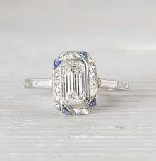 Art deco jewelry pieces are typically characterized by bold details and pronounced geometric forms. Emerald Cut Diamond Art Deco Engagement Wedding Ring Diamondloops
