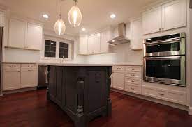 Large, simple square legs are unembellished on this island, except for the furniture base trim along the bottom of both the legs and the island cabinets. Gray Kitchen Island With Turned Post Legs Landhausstil Kuche Philadelphia Von Dremodeling