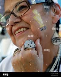 San Antonio Spurs fan Mary Lou Rodriguez poses with a replica Spurs  basketball championship ring prior to an NBA basketball game between the  Spurs and the Dallas Mavericks, Tuesday, Oct. 28, 2014,