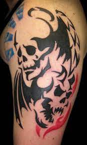 Here we have some feathers thrown into a tribal look. 40 Tribal Skull Tattoos Ideas