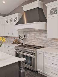 Whether you're looking for a material that will blend into your aesthetic or a modern, streamlined design leaves room to experiment with color and materials, as the fun kitchen above by play associates demonstrates. Modern White Gray Subway Marble Backsplash Tile