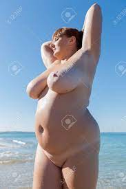 Overweight Middle Aged Woman At The Sea. Nude Overweight Middle-aged Woman  Posing With Arms Raised Stock Photo, Picture and Royalty Free Image. Image  74519813.