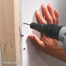 Yes you can put a screw/anchor into a repaired hole, especially if the repair is a superficial one as you describe. How To Install Drywall Diy