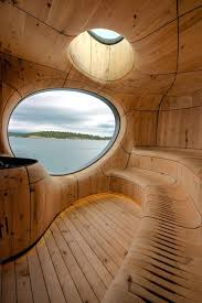 Architecture Partisans Lakeside Sauna Takes The Form Of A Cavernous Wooden Grotto Architecture Sauna Design Amazing Architecture