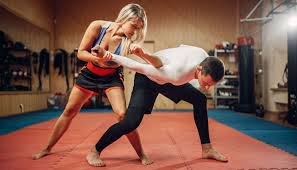 Instructor demonstrating a self-defense technique to a student