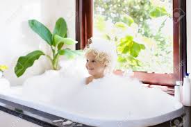 A baby bathtub will help you prop up a wriggling newborn. Little Child Taking Bubble Bath In Beautiful Bathroom With Big Garden View Window Kids Hygiene Shampoo