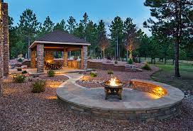 To make your fire pit lounge area even more intimate, consider creating privacy with tall hedges instead of fencing. Outland Living Oakridge Portable Wood Fire Pit