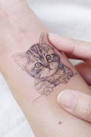 39 Delicate Wrist Tattoos For Your Upcoming Ink Session Cat Tattoo Designs Cat Tattoo Cute Cat Tattoo