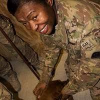 inside back cover photograph of Technical Sergeant Michael A. Jones  rendering a sharp salute. He is the NCOIC Charlie Flight, USAF Honor Guard.  Photograph is part of the article in the August