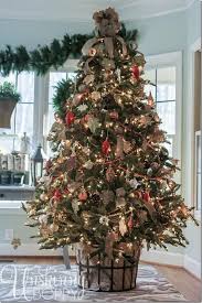Christmas Tree With Bottom Wrapped In Burlap Inside Wrought Iron Basket Decorated With Creative Christmas Trees Christmas Tree Container Christmas Tree Base