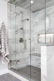 Polished Nickel Towel Hooks Are Mounted Beside A Seamless Glass Steam Shower Featuring A Lighted Bathroom Remodel Shower Master Bathroom Shower Shower Remodel