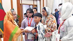 PM hands over a cheque to the family members of deceased Wing Commander  Arif Ahmed Dipu