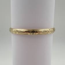 This is a 9ct 1/5th rolled gold bangle with great colour and an engraved floral design on one half. 14 Kt Yellow Gold Engraved Bangle Bracelet S K Ltd