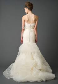 It has metallic micro corded lace applique and opaque seed beads on floral cut out organza, applied to tulle over lace. Vera Wang