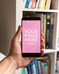 Download Online Mockup Template Featuring A Man Holding A Black Iphone In Hand On A Home Bookshelf Background Place Your Iphone Mockup Photoshop Mockup Free Frame Card