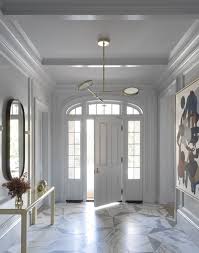 Light Gray Millwork On The Walls Of This Stunning Entry Perfectly Paired With Large Hexagon Marble Floors A Mod Foyer Flooring Floor Design Floor Tile Design