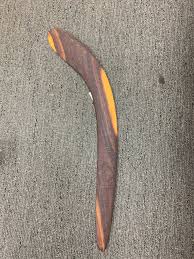 Australians aboriginal craftman holding a wooden australian aboriginal. Aboriginal Weapons