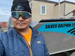 Towing a boat from Igloolik to Arctic Bay, Nunavut, by snowmobile