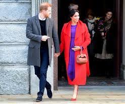 Meghan Markle Pairs A Bright Red Coat With A Purple Dress In Birkenhead Meghan Markle Prince Harry And Meghan Fashion